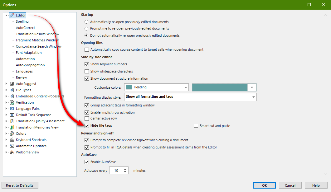 Screenshot of Trados Studio options menu highlighting the 'Editor' section with a red curved line pointing to the 'Hide file tags' option which is checked.
