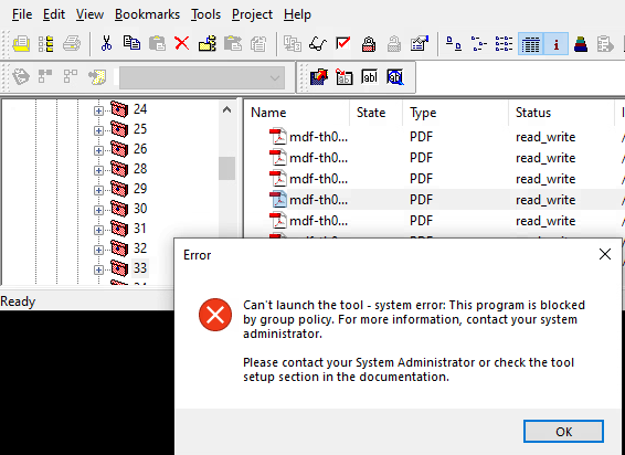 Trados Studio interface showing a list of PDF files with 'read_write' status. An error message popup reads 'Can't launch the tool - system error: This program is blocked by group policy. For more information, contact your system administrator.'