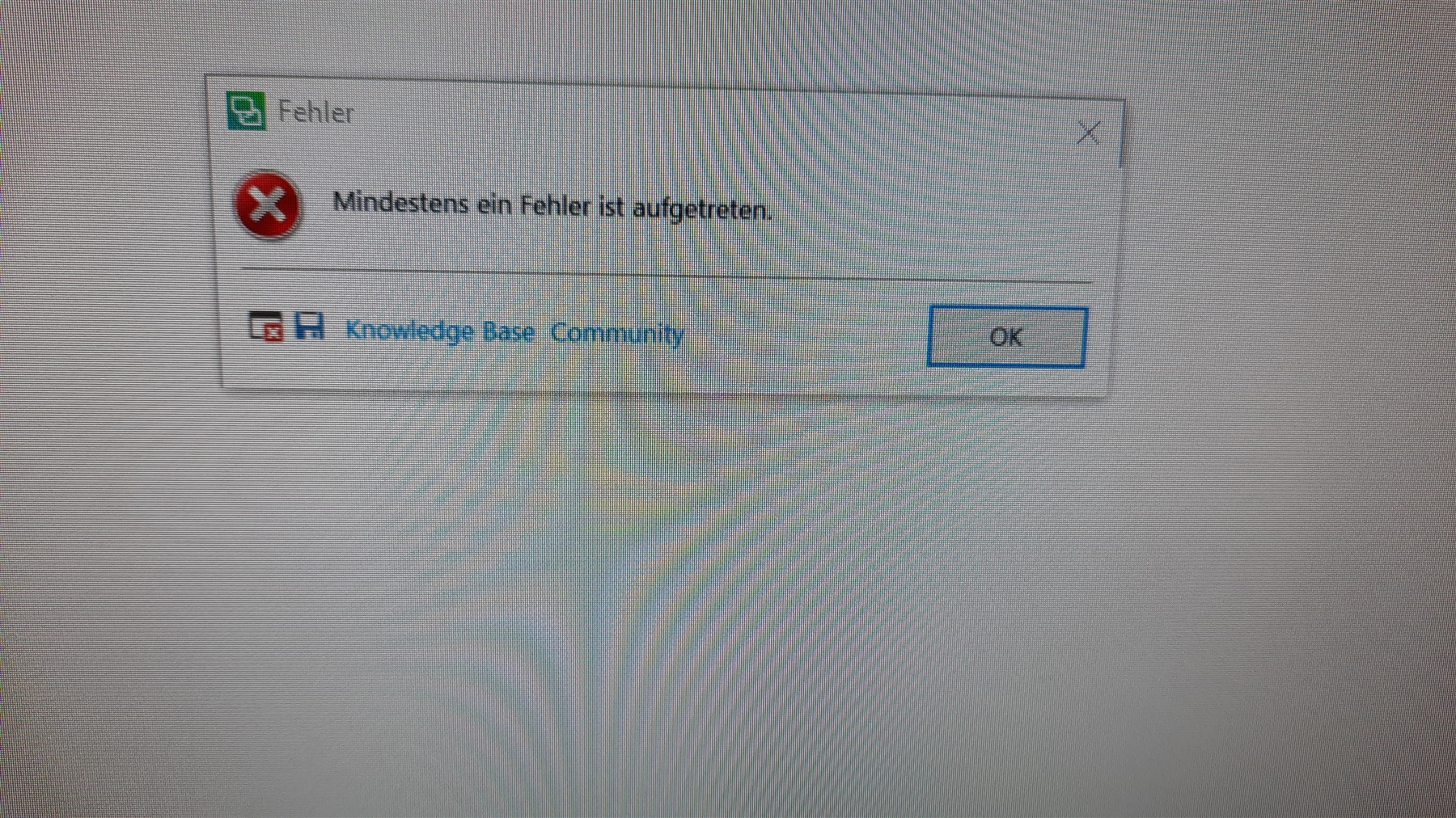 Error message popup in Trados Studio saying 'At least one error has occurred' with an OK button and links to Knowledge Base Community.