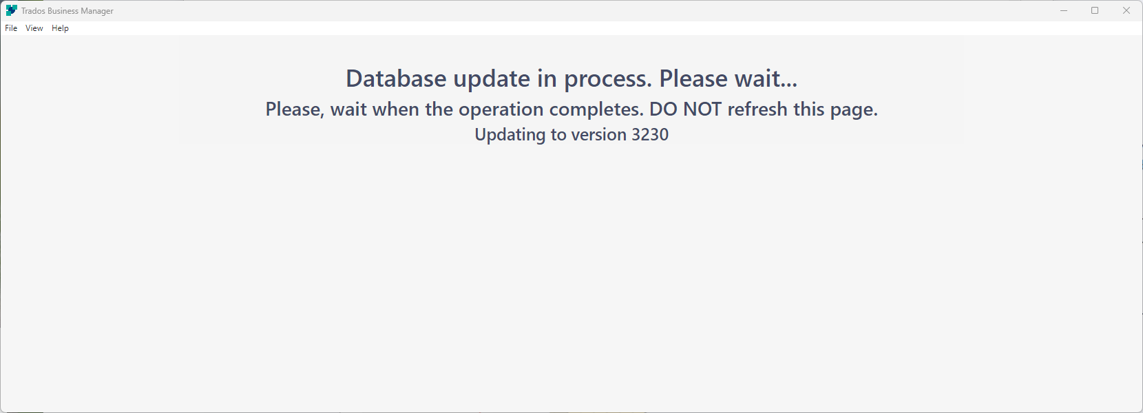 Trados Business Manager screen displaying a message 'Database update in process. Please wait... Please, wait when the operation completes. DO NOT refresh this page. Updating to version 3230'
