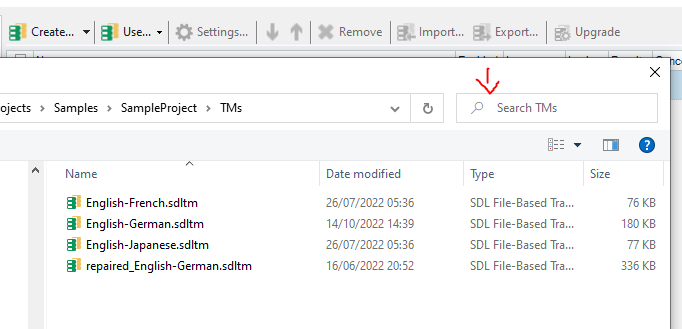 Trados Studio screenshot showing the Translation Memories (TMs) tab with a list of TMs and a 'Search TMs' field highlighted by a red arrow.