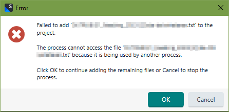 Error dialog box from Trados Studio stating 'Failed to add filename.txt to the project. The process cannot access the file filename.txt because it is being used by another process.' with OK and Cancel buttons.