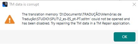 Error message in Trados Studio stating 'TM data is corrupt' with details: 'The translation memory D:DocumentsTRADUCAOMemorias de TraducaoSTUDIOSPLIT2_es-ES_pt-PT.sdltm could not be opened and has been disabled. Try repairing the TM data in a TM Repair application.' An orange warning triangle icon is displayed, and there is an 'OK' button.