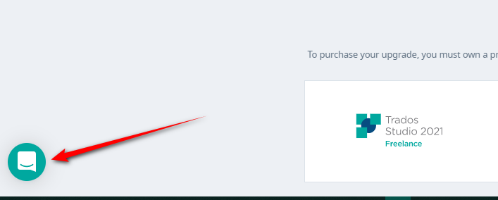 Screenshot showing the Trados Studio 2021 Freelance product page with a red arrow pointing to a chat icon on the lower left of the screen.