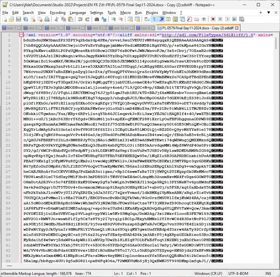 Screenshot of an XLIFF file opened in Notepad++ with illegible content, showing a mix of text and special characters, indicating a possible encoding issue. The file path and encoding UTF-8 BOM are visible at the top.