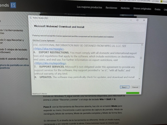 Screenshot of Trados Studio 2022 installation process with a Microsoft WebView2 Download and Install dialog box open, showing license agreement text and a 'Next' button.