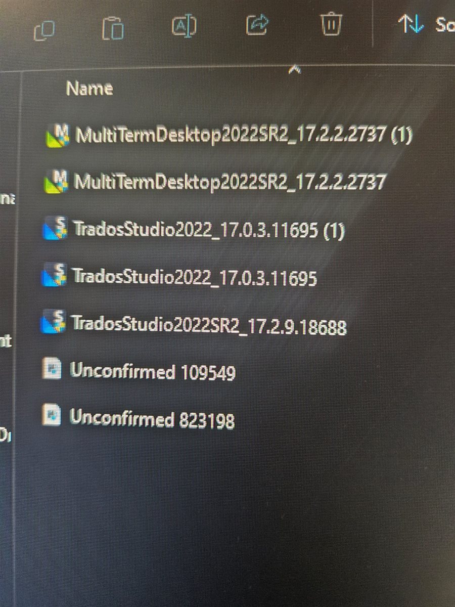 File explorer window displaying downloaded Trados and MultiTerm installation files with some marked as 'Unconfirmed' downloads.