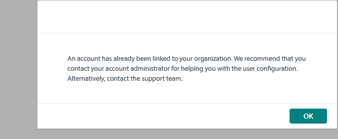 Error message dialog box stating 'An account has already been linked to your organization. We recommend that you contact your account administrator for helping you with the user configuration. Alternatively, contact the support team.' with an OK button.