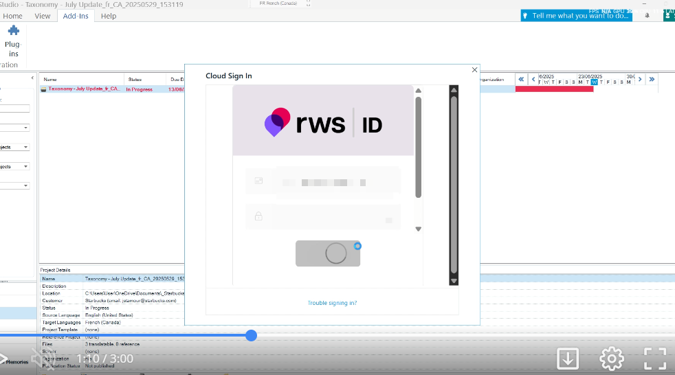 Cloud Sign In window for RWS ID displayed over the Trados Studio interface, showing a loading circle and a 'Trouble signing in?' link at the bottom.