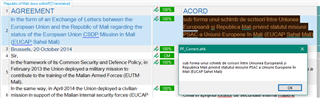 Trados Studio screenshot showing a document titled 'AGREEMENT' with highlighted text in English and French. A warning message box appears indicating a potential issue with the translation.