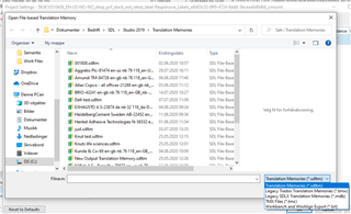 Screenshot of Trados Studio 2019 showing the Open File dialog with a list of TMX files, including one with a long name, selected for import.