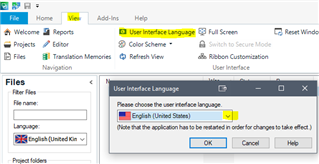 Trados Studio View tab with 'User Interface Language' option selected, showing a dialog box to choose the language with English (United States) highlighted.