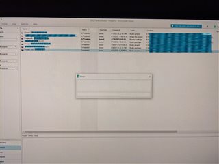 Photo of a computer screen displaying Trados Studio software with an error message window overlaying a frozen interface.