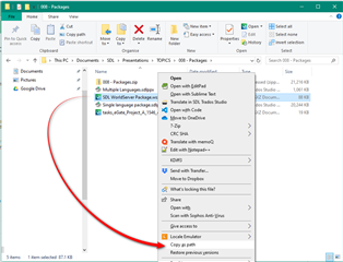 Screenshot showing a right-click context menu in File Explorer with options to open with Trados Studio. A red line points to the 'Open with Trados Studio' option.