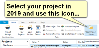 Trados Studio 2019 interface showing the 'Open Project' icon highlighted with a yellow arrow and text bubble saying 'Select your project in 2019 and use this icon...'.