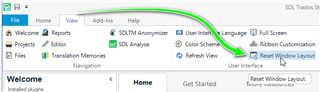 Trados Studio ribbon menu with an arrow pointing to the 'Reset Window Layout' option under the 'View' tab.