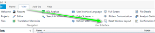 Trados Studio screenshot showing the 'View' tab with an arrow pointing to the 'Reset Window Layout' option.