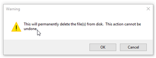 Warning dialog box in Trados Studio with an exclamation mark icon, stating 'This will permanently delete the file(s) from disk. This action cannot be undone.' with OK and Cancel buttons.