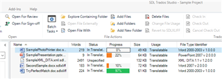 Trados Studio Sample Project window displaying files with statuses such as Unspecified, Translated, and In Translation, along with their progress percentages.