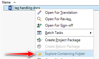 Screenshot of Trados Studio's files view with a right-click context menu open, showing the 'Explore Containing Folder' option highlighted with a red arrow pointing towards it.