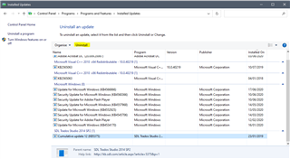 Screenshot of Installed Updates window showing a list of updates with 'SDL Trados Studio 2014' highlighted and an 'Uninstall' option visible.