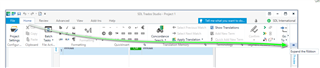 Trados Studio interface with a green arrow pointing to the 'Home' tab and 'Expand the Ribbon' option to restore the normal view.