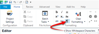 Trados Studio screenshot showing the Editor tab with an arrow pointing to the 'Show Whitespace Characters' button in the toolbar.