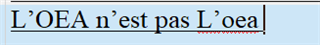 Screenshot of Trados Studio target segment showing text 'L'OEA n'est pas L' oea' with the first 'L' in uppercase and the acronym 'OEA' in lowercase, indicating a capitalization error after using Caps Lock.