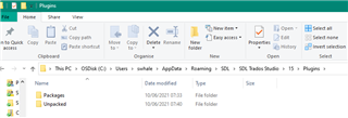File Explorer window showing the Trados Studio Plugins directory with a folder named 'Unpacked' highlighted.