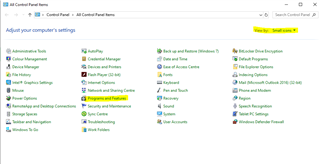 Control Panel window with 'Programs and Features' highlighted in yellow under the 'Adjust your computer's settings' section.