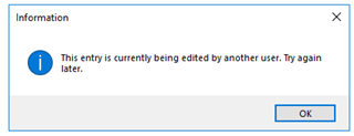 Information dialog box in Trados Studio stating 'This entry is currently being edited by another user. Try again later.' with an OK button.