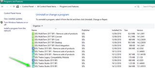 Control Panel window with Programs and Features open, showing a list of installed programs. A green arrow points to SDL Trados Studio 2019 SR1.