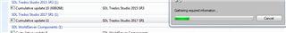 List of installed updates with Trados Studio version highlighted, and an uninstall progress bar indicating action.
