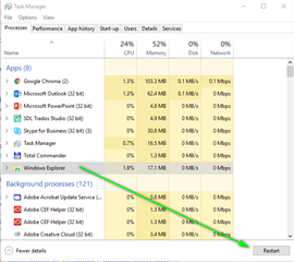 Task Manager window showing a list of running applications, including Google Chrome, Microsoft Outlook, and SDL Trados Studio. Windows Explorer is highlighted with a green arrow pointing to the 'Restart' button.