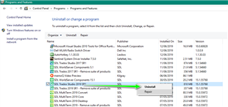 Control Panel's Programs and Features window with a green arrow pointing to 'SDL Trados Studio 2019 SR2' selected for uninstall.