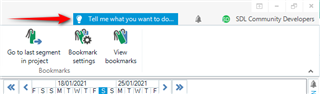 Trados Studio interface showing the 'Tell me what you want to do...' search bar with a red arrow pointing at it.