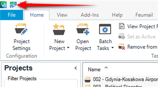 Trados Studio home tab with a red arrow pointing to the 'File' menu option.