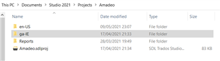 File Explorer window showing Trados Studio 2021 Projects folder with subfolders 'en-US', 'de-DE', 'Reports', and a file 'Amadeus.sdlproj'.