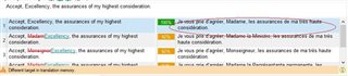 Screenshot showing Trados Studio Ideas translation results window with 'Different target in Translation Memory' warning and track changes highlighting differences in the target field.