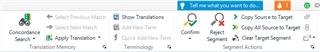 Trados Studio Editor view toolbar with 'Tell me what you want to do' icon next to the Confirm button, and other icons like Copy Source to Target and Clear Segment.