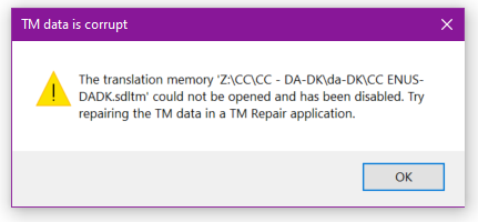 Warning message box stating 'TM data is corrupt' with a message that the translation memory file could not be opened and has been disabled, suggesting to repair the TM data.