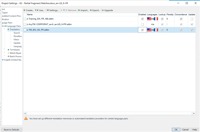 Trados Studio Project Settings window showing a warning message: 'You have set up different translation memories or automated translation providers for certain language pairs.'