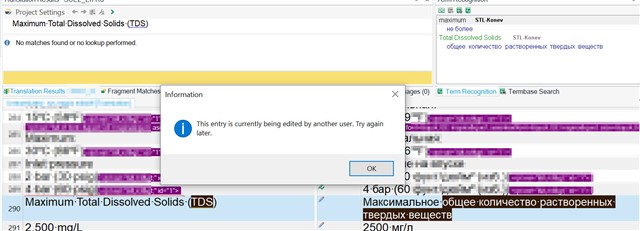 Screenshot of Trados Studio showing an error message 'This entry is currently being edited by another user. Try again later.' in the Information dialog box.