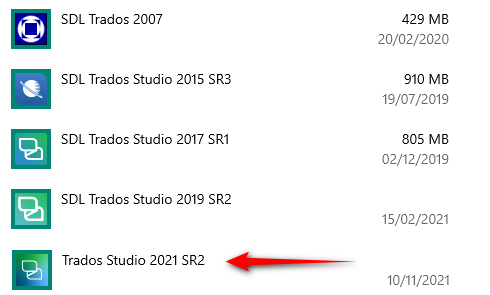 Screenshot showing a list of installed Trados versions with an arrow pointing to Trados Studio 2021 SR2, indicating its location in the list.