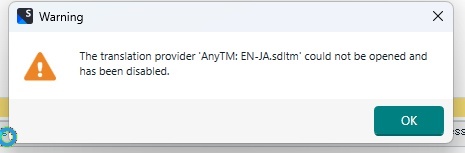 Warning message in Trados Studio stating 'The translation provider AnyTM: EN-JA.sdltm could not be opened and has been disabled.' with an OK button.