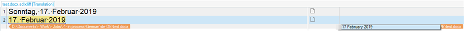 Trados Studio screenshot showing a recognized German date '17. Februar 2019' in the source column and '17 February 2019' in the target column.